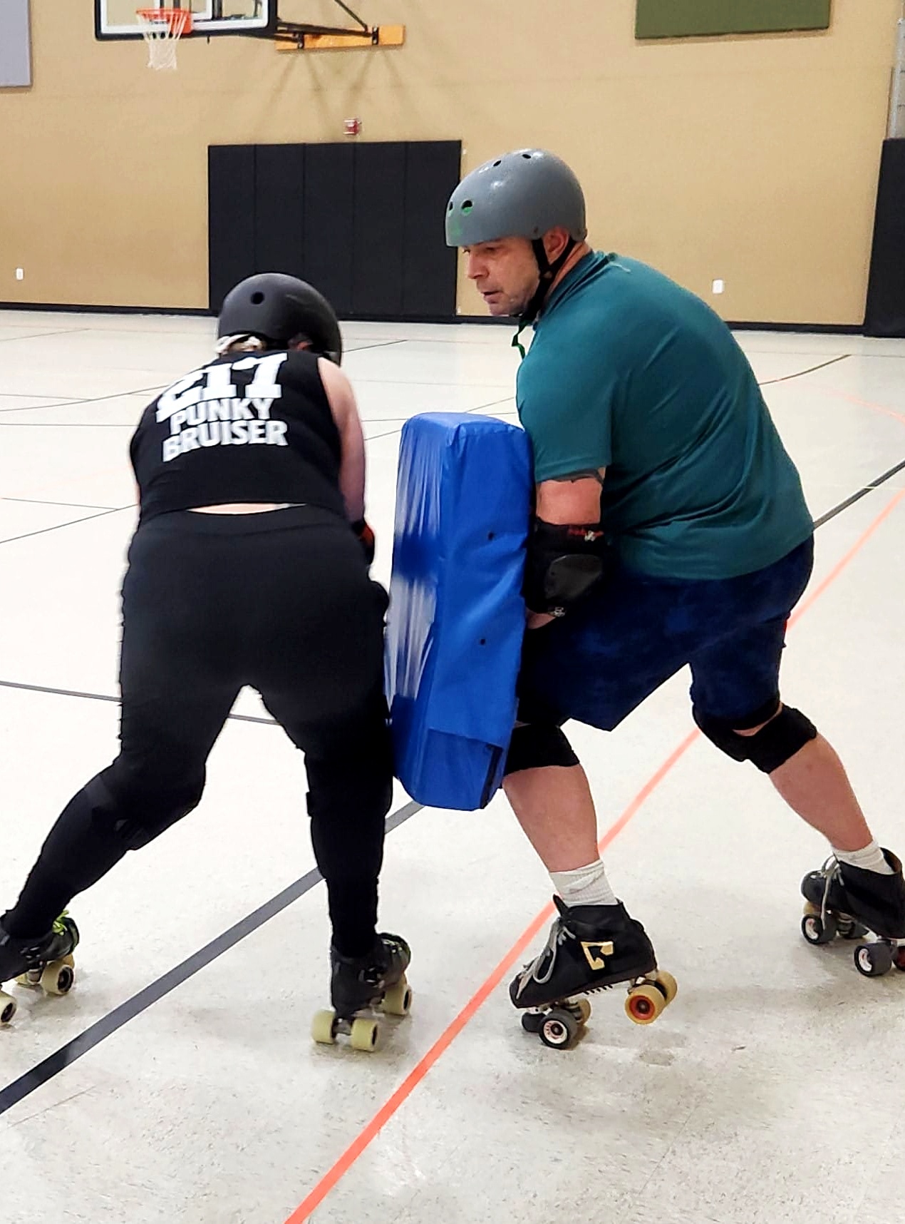 SSRD coach holding hitting bag for player Punky Bruiser